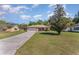 Single story home showcasing a large front yard, long driveway, and mature landscaping at 4530 Old Road 37, Lakeland, FL 33813