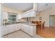 Bright kitchen featuring white cabinetry, a breakfast bar, and seamless access to the dining area at 4530 Old Road 37, Lakeland, FL 33813