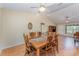 Bright living room featuring high ceilings, a ceiling fan, and a wooden dining table with seating for six at 4530 Old Road 37, Lakeland, FL 33813