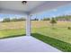 Concrete back patio provides relaxing outdoor views of grass and trees at 9056 Wildlight Trl, Wildwood, FL 34785