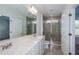 Bathroom with dual sinks and glass enclosed shower at 9056 Wildlight Trl, Wildwood, FL 34785