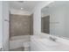 Bathroom featuring a tub with tile surround, single vanity, and large mirror at 9056 Wildlight Trl, Wildwood, FL 34785