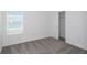 This bedroom features a window, closet with sliding doors and modern gray carpeting at 9056 Wildlight Trl, Wildwood, FL 34785