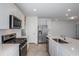 Modern kitchen with stainless steel appliances and white cabinetry at 9056 Wildlight Trl, Wildwood, FL 34785