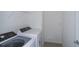 Efficient laundry room with modern washer and dryer units at 9056 Wildlight Trl, Wildwood, FL 34785