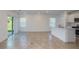 Open-concept living and kitchen area with tile flooring and natural light at 9056 Wildlight Trl, Wildwood, FL 34785