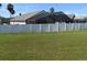 Fenced backyard with well maintained grass and view of the screened in porch at 1124 Liberty Hall Dr, Kissimmee, FL 34746