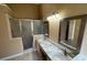 Bathroom featuring double sinks, granite countertops, and a glass enclosed shower at 1124 Liberty Hall Dr, Kissimmee, FL 34746