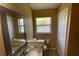 Bathroom featuring a single sink, granite countertop, and a window at 1124 Liberty Hall Dr, Kissimmee, FL 34746