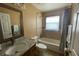 Bathroom featuring granite countertops, sink, toilet, bathtub with shower and a large mirror at 1124 Liberty Hall Dr, Kissimmee, FL 34746