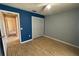 Bedroom featuring bamboo flooring, blue and grey walls, white closet and ceiling fan at 1124 Liberty Hall Dr, Kissimmee, FL 34746