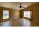 Bright bedroom with wood floors, a ceiling fan, and large windows at 1124 Liberty Hall Dr, Kissimmee, FL 34746