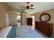 Comfortable bedroom featuring a ceiling fan, wood floors, closet, and ensuite bathroom access at 1124 Liberty Hall Dr, Kissimmee, FL 34746