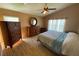 Bedroom with wood floors, a ceiling fan, and plenty of natural light from windows at 1124 Liberty Hall Dr, Kissimmee, FL 34746