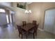 Cozy dining area featuring tile flooring, a traditional chandelier, and neutral wall color at 1124 Liberty Hall Dr, Kissimmee, FL 34746