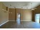 Spacious living room featuring tile flooring, tan walls, two ceiling fans and natural light at 1124 Liberty Hall Dr, Kissimmee, FL 34746