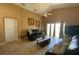 Cozy living room with dark furniture, tile flooring, and sliding glass doors at 1124 Liberty Hall Dr, Kissimmee, FL 34746