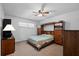 Comfortable bedroom with ceiling fan and a built-in headboard and storage unit at 1203 Lake Miriam Dr, Lakeland, FL 33813