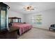 Cozy bedroom features a ceiling fan and plush carpeting, creating a relaxing atmosphere at 1203 Lake Miriam Dr, Lakeland, FL 33813