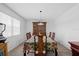 Bright dining room with large window, carpeted flooring, and a dark wood china cabinet as a focal point at 1203 Lake Miriam Dr, Lakeland, FL 33813