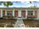 Close up view of the brick home exterior showing a white door and white shuttered windows at 1203 Lake Miriam Dr, Lakeland, FL 33813