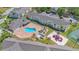 Aerial view showcasing a community pool, playground and well-maintained landscaping between residential buildings at 5005 Laguna Bay Cir # 18, Kissimmee, FL 34746