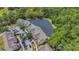 Scenic aerial view featuring a residential community adjacent to a tranquil pond, surrounded by lush green trees at 5005 Laguna Bay Cir # 18, Kissimmee, FL 34746