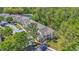 Aerial view of the property showcasing the building, parking, and lake at 5005 Laguna Bay Cir # 18, Kissimmee, FL 34746