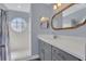 Modern bathroom with a walk-in shower, quartz vanity, and stylish mirror at 5005 Laguna Bay Cir # 18, Kissimmee, FL 34746