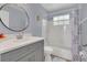 Well-lit bathroom featuring a tub/shower combo and grey vanity at 5005 Laguna Bay Cir # 18, Kissimmee, FL 34746