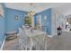 Dining room features blue walls, wood floors and a classic table set for meals with charming coastal décor at 5005 Laguna Bay Cir # 18, Kissimmee, FL 34746