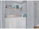 Functional laundry room with a washer, dryer, and shelving for storage at 5005 Laguna Bay Cir # 18, Kissimmee, FL 34746