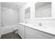 Bright bathroom featuring double vanity with white cabinets and countertop, and a combined tub and shower at 13430 Leaping Water Way, Astatula, FL 34705