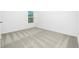 Bedroom featuring neutral carpet, bright white walls and a window for a clean and relaxing atmosphere at 13430 Leaping Water Way, Astatula, FL 34705