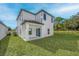 Two-story home featuring a well-manicured lawn and a modern exterior with a covered patio space at 13430 Leaping Water Way, Astatula, FL 34705