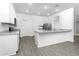 Bright kitchen featuring stainless steel appliances and an island with a granite countertop at 13430 Leaping Water Way, Astatula, FL 34705