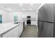 Bright kitchen featuring stainless steel appliances, granite countertops, and white cabinets at 13430 Leaping Water Way, Astatula, FL 34705