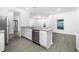 Bright kitchen with an island featuring stainless steel appliances and a granite countertop at 13430 Leaping Water Way, Astatula, FL 34705