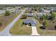 Aerial view of a home with a two-car garage, long driveway and expansive lawn at 13581 Sw 48Th Ct, Ocala, FL 34473