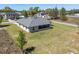 Aerial view of a single-story home with a screened-in patio and large lawn at 13581 Sw 48Th Ct, Ocala, FL 34473