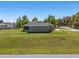 Aerial view of a home with a large lawn and screened-in back patio at 13581 Sw 48Th Ct, Ocala, FL 34473