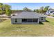 Spacious backyard featuring a screened lanai and lush green grass at 13581 Sw 48Th Ct, Ocala, FL 34473