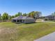 Green lawn with house and screened in porch at 13581 Sw 48Th Ct, Ocala, FL 34473