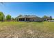 Landscaped backyard features the screened in porch, and green grass at 13581 Sw 48Th Ct, Ocala, FL 34473