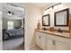 Ensuite bathroom boasting double sinks, granite countertops and custom mirrors at 13581 Sw 48Th Ct, Ocala, FL 34473
