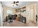 Well-lit carpeted bedroom featuring a home office with natural light at 13581 Sw 48Th Ct, Ocala, FL 34473