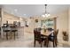 Open dining room with tile flooring, bright lighting, and adjacent breakfast bar at 13581 Sw 48Th Ct, Ocala, FL 34473