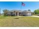 Inviting single-story home with a two-car garage, manicured lawn, and mature landscaping at 13581 Sw 48Th Ct, Ocala, FL 34473