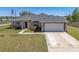 Inviting single-story home with a two-car garage and well-manicured lawn and landscaping at 13581 Sw 48Th Ct, Ocala, FL 34473