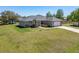 Well-maintained home with a two-car garage and sprawling green lawn at 13581 Sw 48Th Ct, Ocala, FL 34473